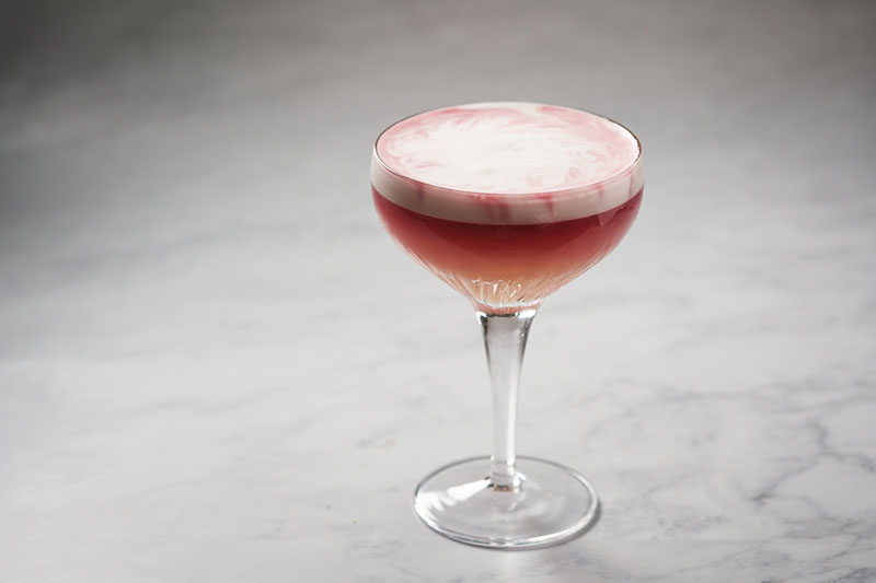 Image of pink cocktail with egg white foam